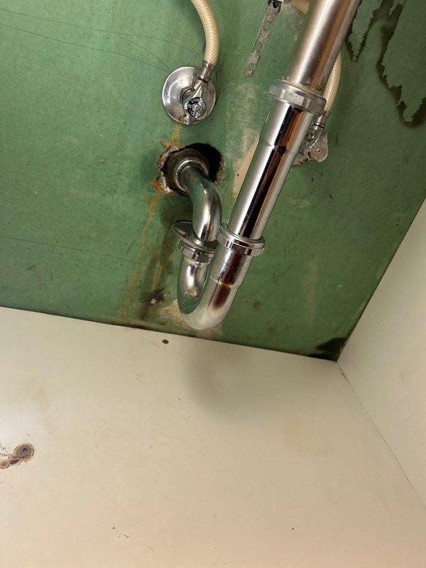 Responded to a clogged drain affecting both the bathroom sink and shower, where running the sink caused water backup in the shower. Removed a large accumulation of hair, soap residue, and organic debris from the shared drain line using mechanical extraction methods. Inspected the P-trap assembly and overhead drainage piping, noting existing water damage and rust staining on surrounding surfaces, and verified proper water flow through both fixtures upon completion.
