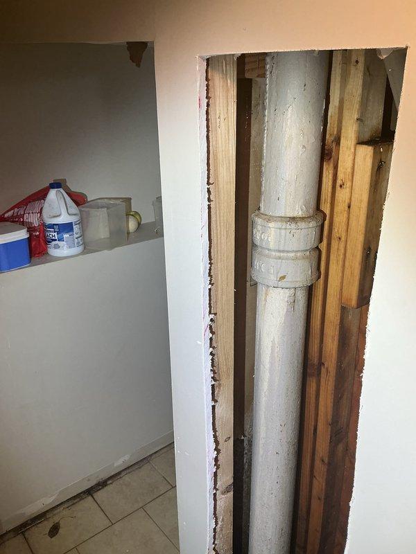 Responded to emergency service call for homeowner unable to use kitchen plumbing. Upon arrival, accessed main plumbing stack by opening interior wall to expose vertical drain and vent system. Located and repaired defective section of white PVC waste line running between wall studs. Work included cutting away drywall to access compromised piping, replacing damaged fittings and joints on main drain stack, and addressing issues with secondary gray PVC drain lines and associated couplings. All plumbing connections tested and verified operational to restore full kitchen functionality.