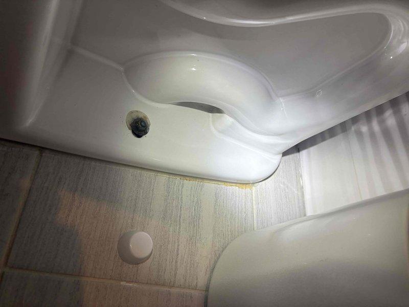 Responded to service call for sewer odors in first-floor powder room and water leak from second-floor toilet causing ceiling damage below. Upon inspection, identified water staining on flooring adjacent to toilet base and confirmed improper seal as source of both issues. Removed both affected standard gravity toilets and conducted thorough flange inspection and cleaning. Replaced wax seals with new wax/putty rings, installed new closet bolts, and properly reset both toilets to manufacturer specifications. Verified proper seating and seal integrity upon completion. All work covered under lifetime workmanship warranty.