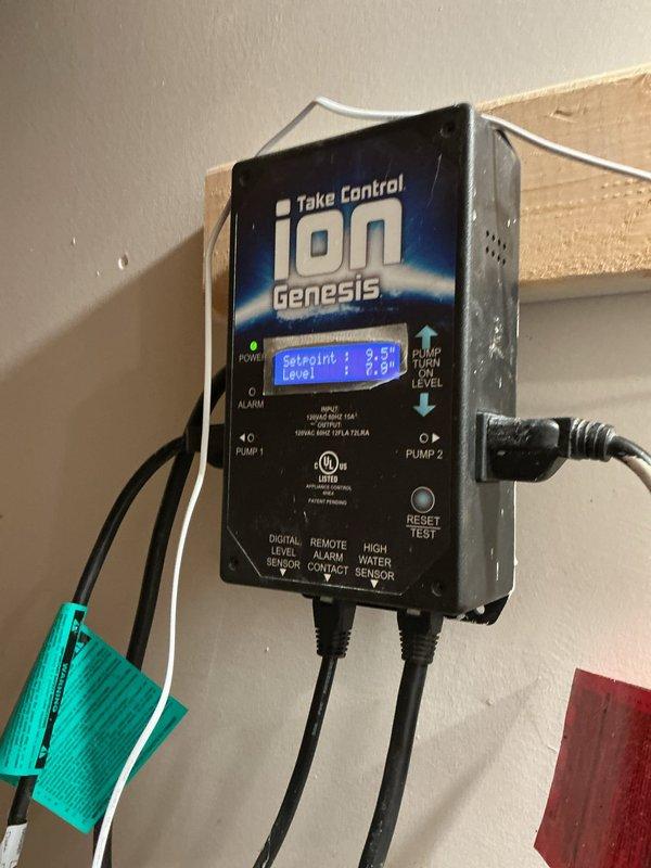 Responded to a tankless water heater concern in a 124-year-old residential property where the homeowner reported a suspected gas leak odor that had been present for approximately two weeks. Upon arrival, inspected the non-operational tankless unit of the two installed systems. Investigation revealed the issue was likely related to exhaust ventilation rather than an active gas leak. Documented existing HVAC and mechanical system conditions in the basement utility area, including air handler unit and associated control systems. Unit showed signs of extended service without recent maintenance, with visible dust accumulation on equipment surfaces. Photographed Ion Genesis water level control system and surrounding mechanical installations for service records.