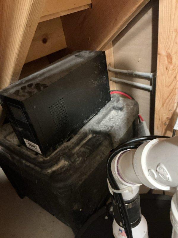 Responded to a tankless water heater concern in a 124-year-old residential property where the homeowner reported a suspected gas leak odor that had been present for approximately two weeks. Upon arrival, inspected the non-operational tankless unit of the two installed systems. Investigation revealed the issue was likely related to exhaust ventilation rather than an active gas leak. Documented existing HVAC and mechanical system conditions in the basement utility area, including air handler unit and associated control systems. Unit showed signs of extended service without recent maintenance, with visible dust accumulation on equipment surfaces. Photographed Ion Genesis water level control system and surrounding mechanical installations for service records.