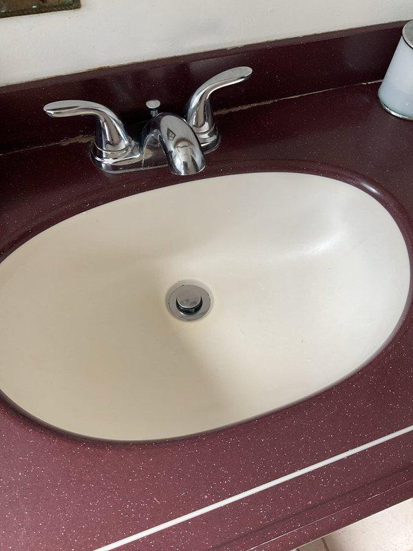 Responded to a clogged bathroom sink call and successfully cleared the blockage. Accessed the P-trap assembly beneath the undermount sink, removed debris causing the obstruction, and verified proper drainage function before completing the service.