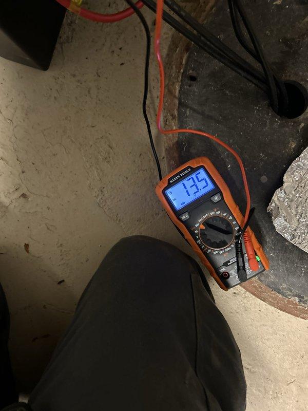 Performed comprehensive sump pump inspection per customer request. Evaluated pump operation, electrical functionality, and overall system condition. Visual inspection revealed significant mineral deposits and hard water staining throughout the basin walls, indicating prolonged exposure to high mineral content water. Sump pump assembly showed normal wear consistent with regular use, with float switch mechanism and discharge piping intact. Tested electrical voltage at pump, recording 135 volts to verify proper power supply. Observed standing water in basin with pump components functioning as designed. Documented system condition with photographs for customer records, noting mineral buildup on basin surfaces and general maintenance status of pump assembly and discharge configuration.
