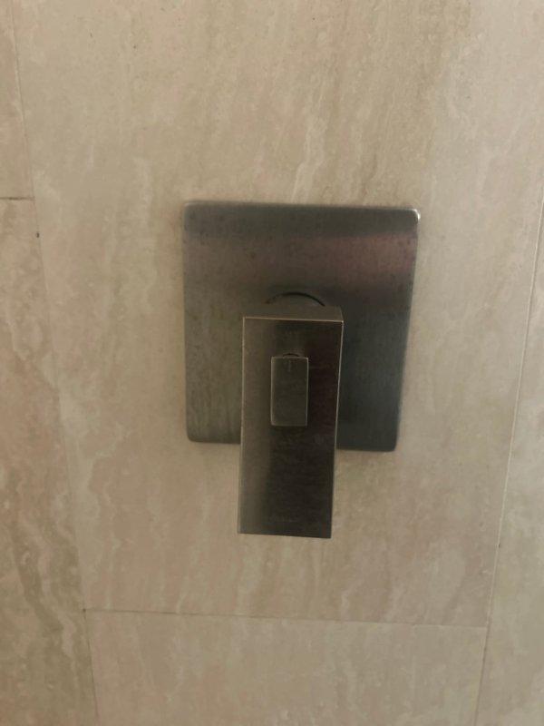 Responded to service call for low water pressure at outdoor spigot and malfunctioning shower temperature control. Diagnosed and identified faulty shower cartridge requiring replacement. Inspected existing sump pump system and provided estimate for replacement unit. Documented plumbing system configuration including copper supply lines, PVC drainage components, and water heater installation for service records.