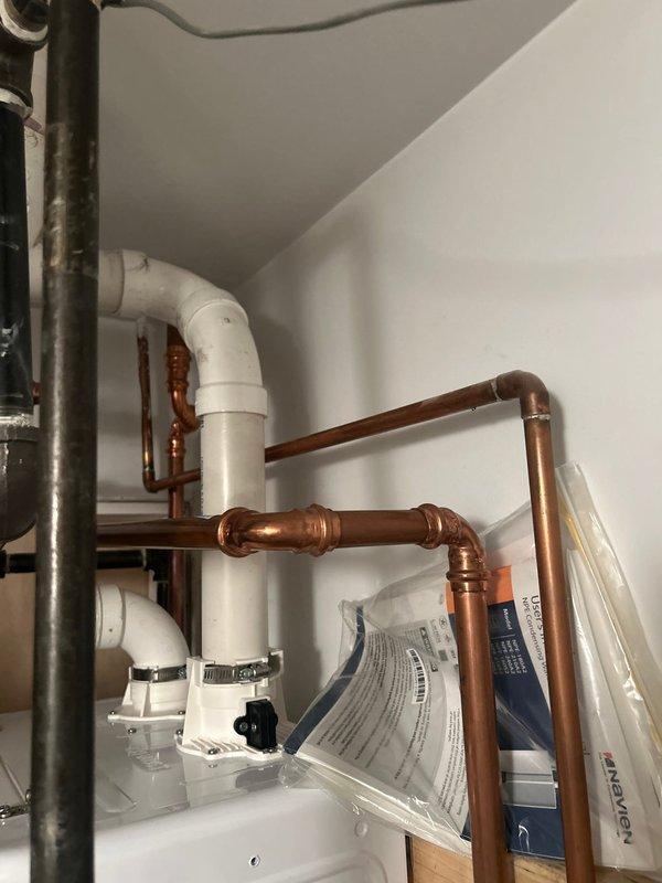 Responded to service call for low water pressure at outdoor spigot and malfunctioning shower temperature control. Diagnosed and identified faulty shower cartridge requiring replacement. Inspected existing sump pump system and provided estimate for replacement unit. Documented plumbing system configuration including copper supply lines, PVC drainage components, and water heater installation for service records.