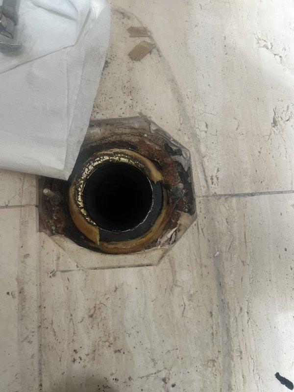 Responded to service call for toilet leaking from the bottom. Upon inspection, identified water leakage at the base of the toilet with visible water staining and discoloration on the floor tiles surrounding the toilet flange area. Diagnosed issue as likely wax ring failure or compromised toilet base seal, requiring toilet removal and reinstallation with new wax ring and flange hardware to resolve the leak and prevent further water damage to the flooring.