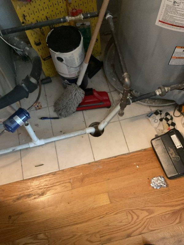 Responded to report of water leaking from basement ceiling below an upper-level A/C unit, with suspected clog in A/C condensate drain line. Performed camera inspection of plumbing and HVAC drain system to identify source of intermittent leaking that occurs during humid weather when air conditioning units are in heavy operation. Documented utility area conditions including water heater installations, PVC drainage piping, and ceiling-mounted HVAC vent locations to assess potential drainage pathway issues in the 20-year-old residential system.