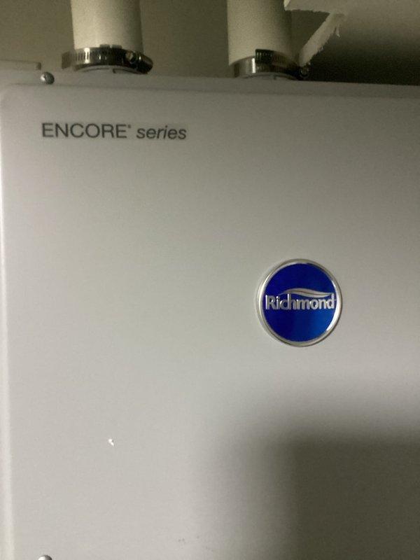 Responded to service call for Richmond Encore series water heater displaying error code and audible beeping alarm. Performed diagnostic inspection of unit and digital controller panel showing 29°C temperature reading. Documented equipment condition and controller display for estimate preparation. Provided commercial drain and sewer estimate for proceeding with necessary repairs to resolve error code condition and restore proper water heater operation.