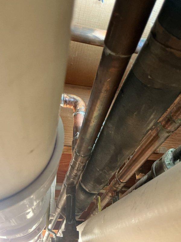 Responded to water leak on main supply line feeding water heater in basement. Upon inspection, identified active leak at connection point between main line and water heater supply piping. Repaired compromised connection on aging copper and steel pipe system, verified all joints for integrity, and tested system under full pressure to confirm leak resolution and proper water flow to water heater.