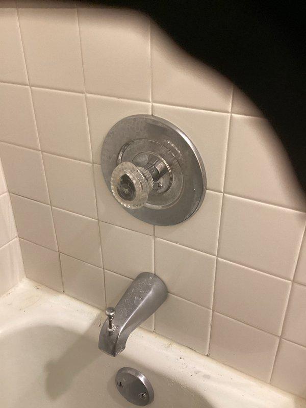 Responded to emergency building shutdown to address bathtub and shower fixture failure. Removed deteriorated chrome tub spout and shower valve assembly from white subway-tiled wall, exposing copper supply lines for replacement. Installed new chrome bathtub faucet and shower control system with updated valve trim plate and clear acrylic control handle, ensuring proper connections to existing plumbing infrastructure and restoring full water service to the fixture.