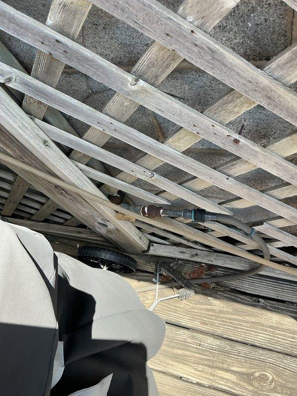 Responded to emergency call for gas line servicing exterior line behind garage connected to outdoor grill. Upon arrival, accessed the gas line located beneath the deck structure behind the garage. Conducted thorough inspection of the gas line routing and connections. Performed pressure test on the gas line system to verify integrity and identify any leaks in the line. Inspected all fittings, connections, and pipe runs from the main gas supply through to the grill connection point. Verified proper gas flow and pressure readings throughout the system. All connections tested and confirmed secure with no active leaks detected at time of service completion.