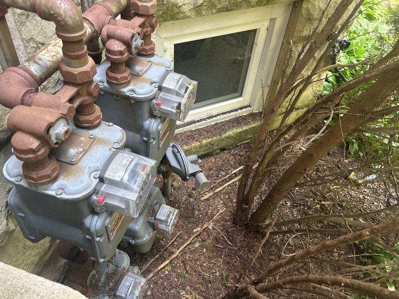 Responded to request for gas line modifications in residential property. Assessed two existing gas lines requiring shortening—one located in laundry room area and one in kitchen. Upon arrival, conducted visual inspection of gas meter assembly and associated copper piping at exterior of building, noting existing corrosion and oxidation on connections. Evaluated interior gas line routing in laundry room, identifying black-handled shutoff valve and existing copper supply line configuration. Provided detailed estimate for shortening both gas lines to customer specifications, including materials, labor, and code-compliant installation procedures to ensure proper gas flow and safety standards are maintained.