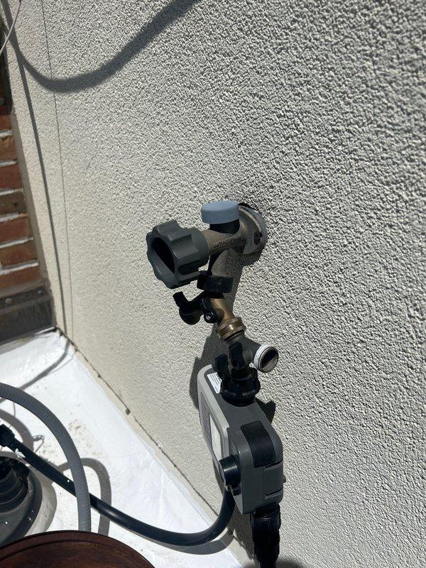 Installed new outdoor spigot with frost-free valve assembly featuring quarter-turn operation and copper supply line connection. Addressed existing water leakage concerns by replacing deteriorated drivis walling with enhanced weatherproof sealant superior to standard clear silicone for improved durability and moisture protection. Completed exterior wall mounting with proper pipe fittings and secured all connections to ensure leak-free operation.
