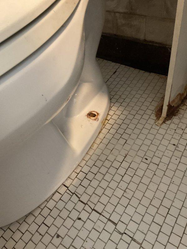 Responded to service call for clogged toilet with reported foreign object obstruction. Upon arrival, found water supply already shut off by customer. Assessed bathroom conditions and documented existing deteriorated flooring, damaged wall sections, and aging fixtures prior to beginning work. Successfully cleared toilet obstruction and restored proper drainage function.