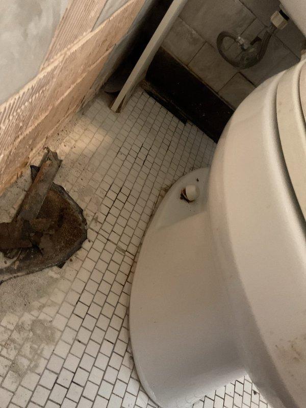 Responded to service call for clogged toilet with reported foreign object obstruction. Upon arrival, found water supply already shut off by customer. Assessed bathroom conditions and documented existing deteriorated flooring, damaged wall sections, and aging fixtures prior to beginning work. Successfully cleared toilet obstruction and restored proper drainage function.
