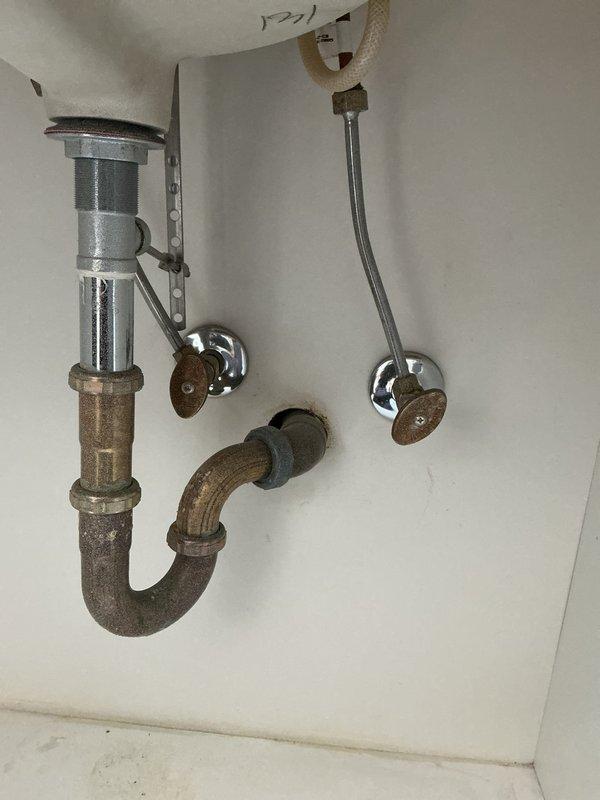 Replaced four aging faucets throughout the residence with customer-supplied fixtures, including installation of a three-handle chrome faucet assembly with center spout on a granite vanity countertop with undermount sink. Installed new drain assemblies and P-traps, connected water supply lines, and tested all fixtures for proper operation and leak-free performance. Repaired leaking exterior hose bibb in garage by replacing damaged anti-siphon valve components where internal fixture parts had broken off, restoring full functionality to the outdoor water supply.