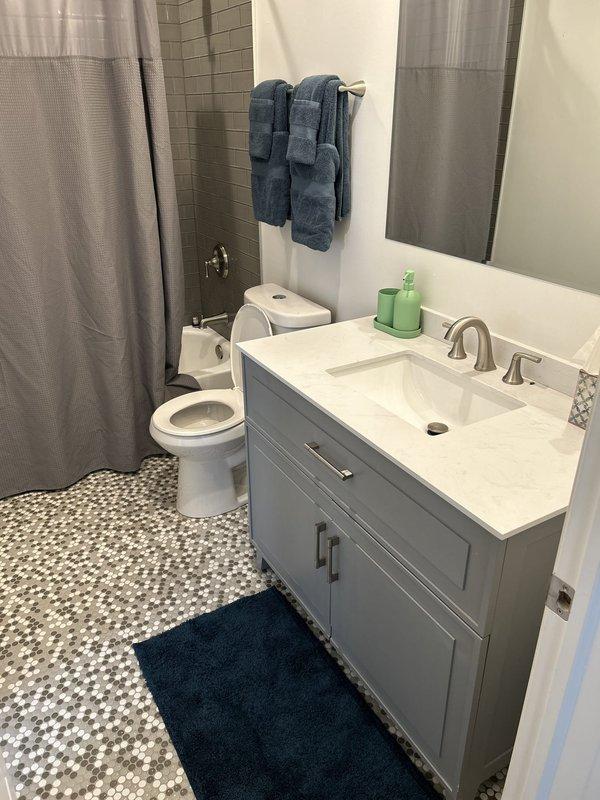 Responded to priority service call for outdoor hose bib repair and indoor shower drain inspection. Repaired malfunctioning outdoor spigot to restore proper water flow and eliminate leaks. Conducted thorough inspection of interior bathroom shower drain system, including examination of penny tile mosaic shower floor and drainage components to ensure proper function and identify any potential plumbing issues. All fixtures tested and confirmed operational upon completion.