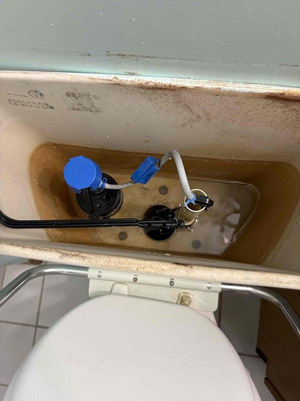 Responded to service call for non-functioning water heater with reported leak and no hot water availability. Upon arrival, conducted visual inspection and diagnostic assessment of the plumbing system. Documented existing conditions through photographic evidence showing significant water quality issues, including discolored water with brownish-amber tint indicating mineral deposits and potential rust contamination throughout the plumbing fixtures. Observed extensive rust staining on ceramic surfaces, particularly around waterlines and metal component interfaces, suggesting prolonged exposure to compromised water quality and aging infrastructure. Prepared comprehensive estimate for water heater replacement, including assessment of associated plumbing components and recommendation for addressing underlying water quality concerns to prevent premature failure of new equipment.