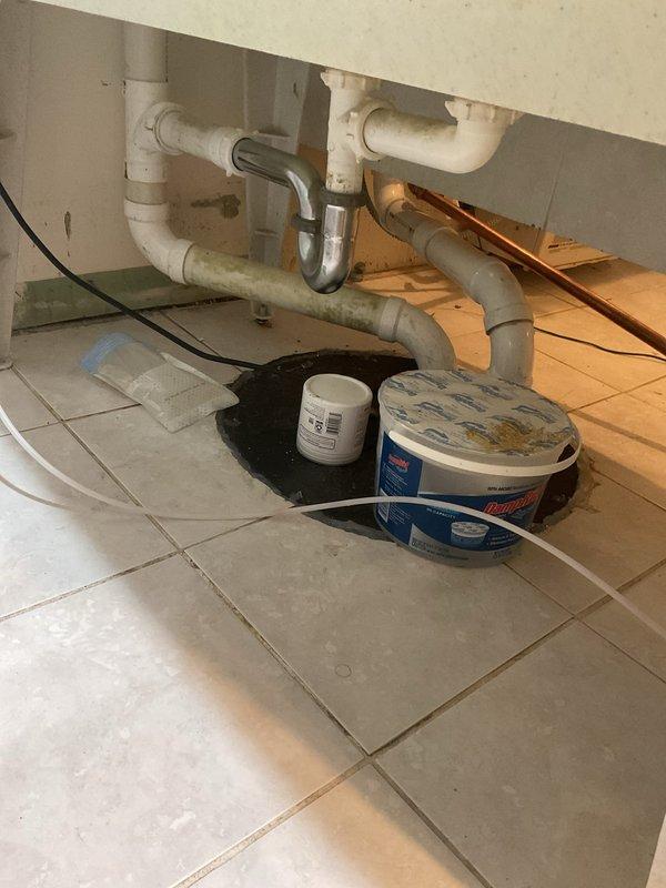 Responded to basement flooding concern related to ejector pump system. Conducted thorough inspection of ejector pump pit to assess for blockages or mechanical failures that may have caused storm drain overflow. Evaluated pump operation, discharge piping, and check valve function to determine root cause of backup. Additionally inspected and assessed damaged piping connected to exterior hose bib in basement requiring repair. Documented plumbing conditions with photographs including under-sink drainage systems and copper supply line installations with compression fittings in crawl space area.