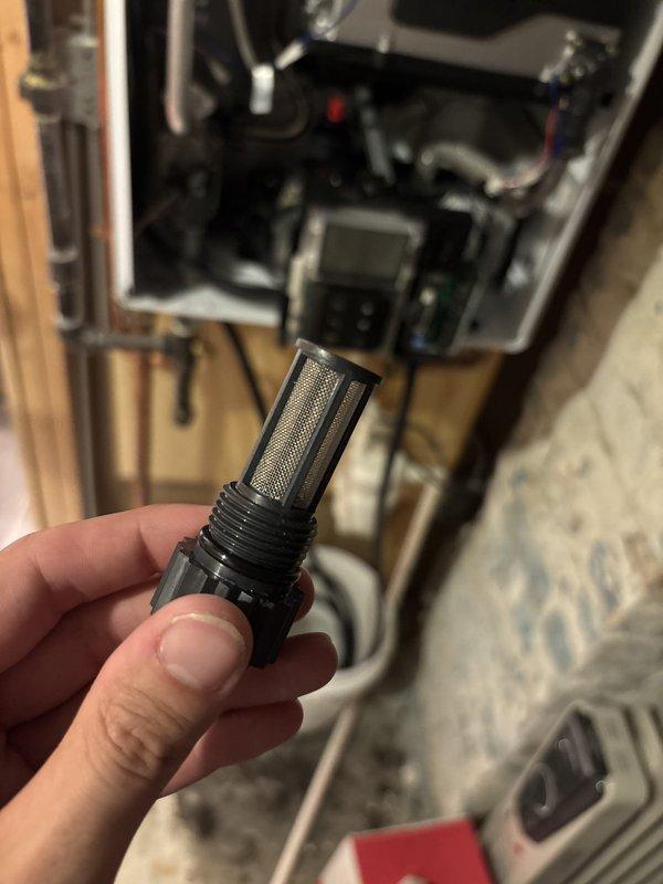 Responded to service call for Navien tankless water heater displaying red error code indicating PCB malfunction. Upon inspection, removed and cleaned inlet filter screen which had accumulated debris, potentially causing flow restriction and triggering false error code. Verified all electrical connections to printed circuit board were secure, tested unit operation, and confirmed system returned to normal function with error code cleared and hot water delivery restored.