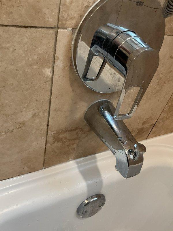 Responded to ongoing leak complaint and performed diagnostic inspection of bathtub plumbing system. Accessed wall cavity through existing opening to examine copper supply piping and shower valve assembly. Inspected chrome-finished single-handle mixing valve, tub spout, and associated connections for signs of water intrusion. Documented conditions with photos showing rough-in plumbing, valve trim installation, and surrounding tile work. Leak source not definitively identified during this visit; further investigation required to isolate and resolve the issue.