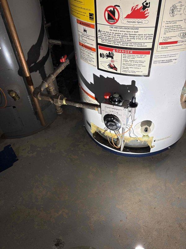 Performed comprehensive inspection and documentation of existing gas-fired tanked water heater installation in residential utility space. Unit evaluated for proper operation, safety compliance, and overall condition. Verified copper supply and discharge piping connections, gas valve assembly, temperature and pressure relief valve, and thermostat control functionality. Documented current state of installation including warning labels, energy guide information, and all safety placards for service records. Noted age-related discoloration at tank base and minor surface wear consistent with normal operational use.