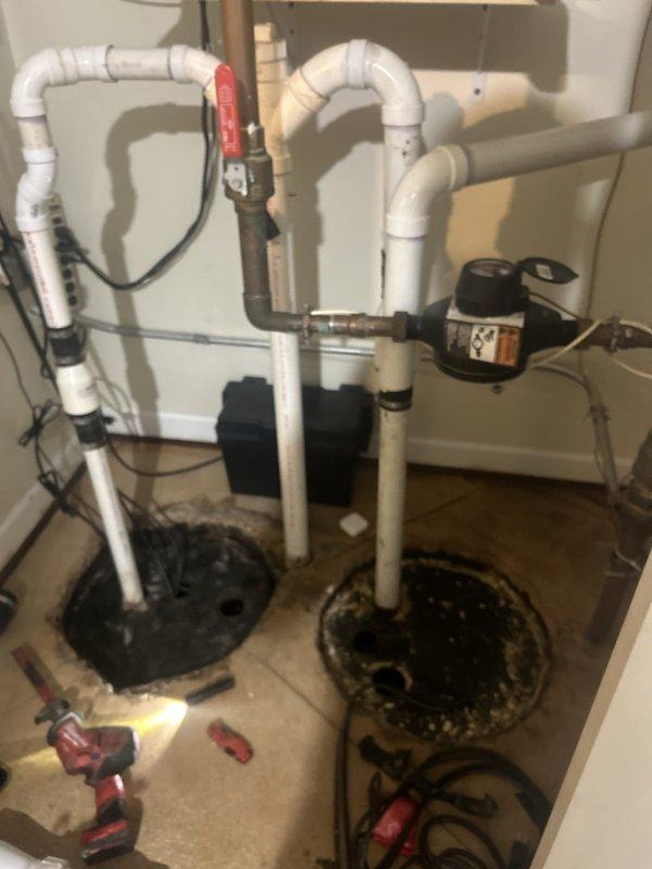 Responded to a sump pump fault in basement that had been ongoing for four days. Upon arrival, assessed the existing dual sump pump system installed in separate pits within the concrete floor. Performed diagnostic testing on both pump units to identify the source of the malfunction. Inspected electrical connections, float switches, and discharge piping configuration including PVC runs with ball valves. Verified proper operation of both black sump pump motors and checked all vertical and horizontal discharge lines for obstructions or improper drainage. Tested the electrical control systems and confirmed adequate power supply to both units. Made necessary adjustments to restore full functionality to the sump pump system, ensuring proper water removal capability for the basement area. System returned to normal operation with both pumps cycling correctly.