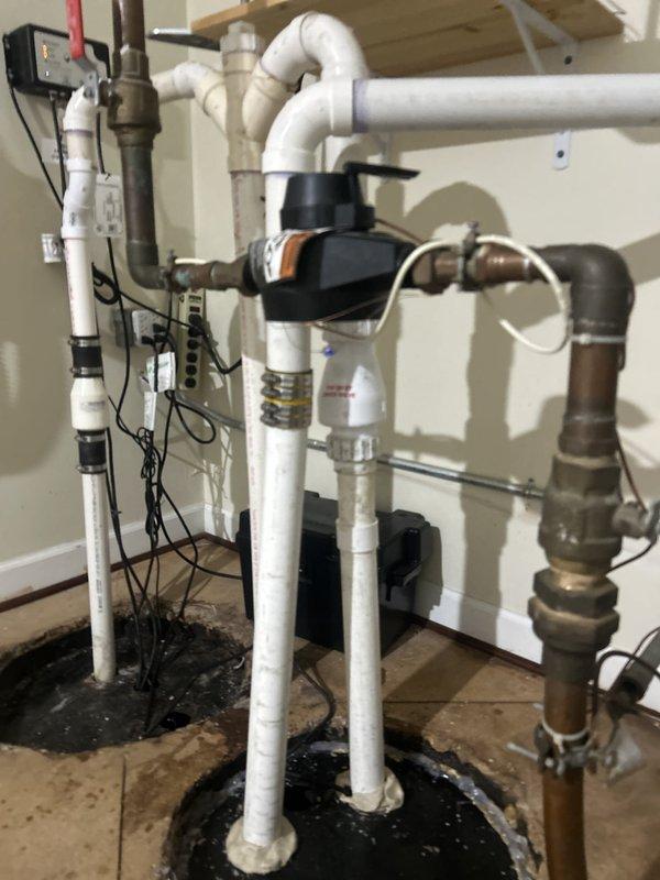 Responded to a sump pump fault in basement that had been ongoing for four days. Upon arrival, assessed the existing dual sump pump system installed in separate pits within the concrete floor. Performed diagnostic testing on both pump units to identify the source of the malfunction. Inspected electrical connections, float switches, and discharge piping configuration including PVC runs with ball valves. Verified proper operation of both black sump pump motors and checked all vertical and horizontal discharge lines for obstructions or improper drainage. Tested the electrical control systems and confirmed adequate power supply to both units. Made necessary adjustments to restore full functionality to the sump pump system, ensuring proper water removal capability for the basement area. System returned to normal operation with both pumps cycling correctly.