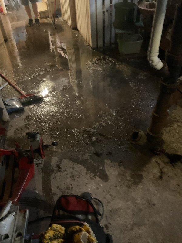 Responded to a clogged sewer line that had been causing issues for two days. Upon arrival, found significant water backup and flooding in the basement utility area affecting the main sewer line assembly. Cleared the blockage in the sewer line using professional drain cleaning equipment, restoring proper flow and drainage. Tested the system to confirm full functionality and began water extraction from the affected basement area.