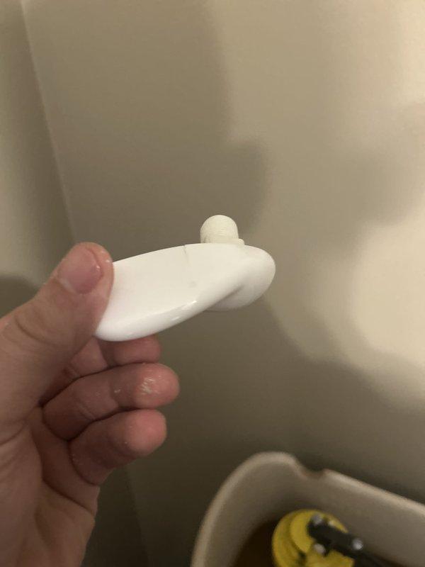 Responded to service call for malfunctioning toilet with broken handle mechanism. Upon inspection, diagnosed failed flush valve flapper and associated linkage components within the tank. Removed defective white plastic flush valve assembly and stopper mechanism that had deteriorated, preventing proper flushing operation. Replaced faulty components with new flush valve flapper and reinstalled hardware to restore full functionality. Tested flush mechanism multiple times to ensure proper operation and water seal. Toilet now operates normally with handle engaging flush valve correctly.