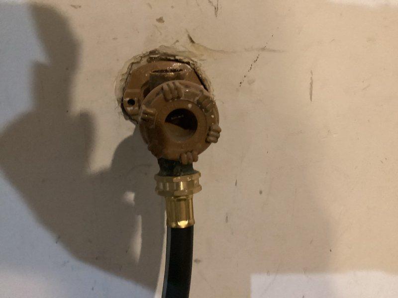 Installed new faucet valve assembly with brass fixture and flexible supply line connection. Addressed water heater temperature setting, verified tankless unit operating at 126°F with proper venting and supply line connections intact.