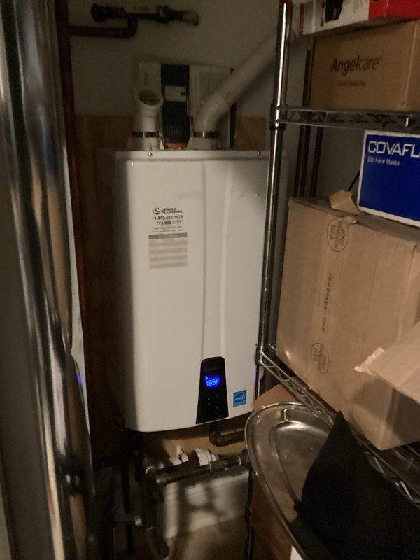 Installed new faucet valve assembly with brass fixture and flexible supply line connection. Addressed water heater temperature setting, verified tankless unit operating at 126°F with proper venting and supply line connections intact.