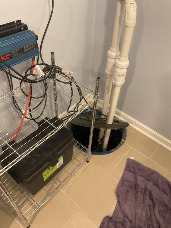 Scheduled follow-up diagnostic appointment for next week to evaluate Champion backup sump pump system installed in 2025, currently under warranty. Documented existing system configuration including battery backup unit, PVC discharge piping, and dual float switch assembly in utility room sump basin.