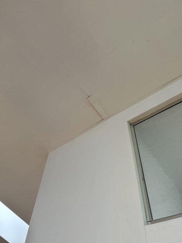 Responded to plumbing installation callback to investigate reported leak concerns. Performed thorough visual inspection of bathroom ceiling and ventilation system. Documented existing circular moisture staining around ceiling-mounted exhaust fan, indicating previous water intrusion or condensation accumulation. Examined ceiling seams, skylight interface, and wall-to-ceiling junctions for active moisture penetration. Captured photographic documentation of stained areas and ceiling conditions for service records. No active leaking observed at time of inspection.
