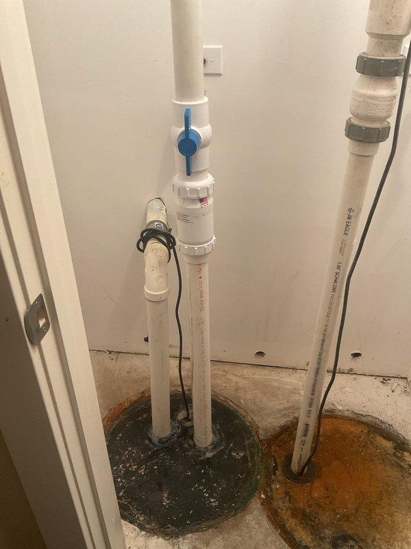 Responded to emergency plumbing call for basement toilet backing up into shower and multiple slow-draining fixtures. Upon arrival, discovered significant water damage and standing water in utility closet area with visible orange-brown discoloration indicating sewage backup. Performed main drain line inspection and identified blockage in primary sewer line causing backup into lower-level fixtures. Cleared obstruction using drain snake equipment, restoring proper flow to basement toilet and shower. Addressed slow-draining sinks by clearing secondary drain lines of accumulated debris and buildup. Tested all affected fixtures to confirm proper drainage and verified no additional blockages in system. Noted water staining on concrete floor and around pipe penetrations indicating previous overflow events. Recommended monitoring for recurring issues and potential camera inspection of main sewer line to assess condition and identify any underlying problems such as root intrusion or pipe deterio