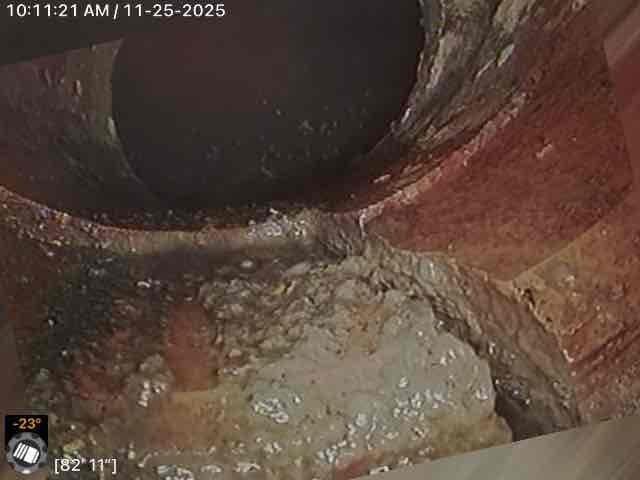 Completed main line drain and sewer installation in utility room workspace. Accessed confined crawlspace area beneath structure where significant sediment and moisture accumulation was present around existing brick foundation walls. Installed new main line piping system, ensuring proper grade and connection points while navigating tight access conditions and removing debris from work area.