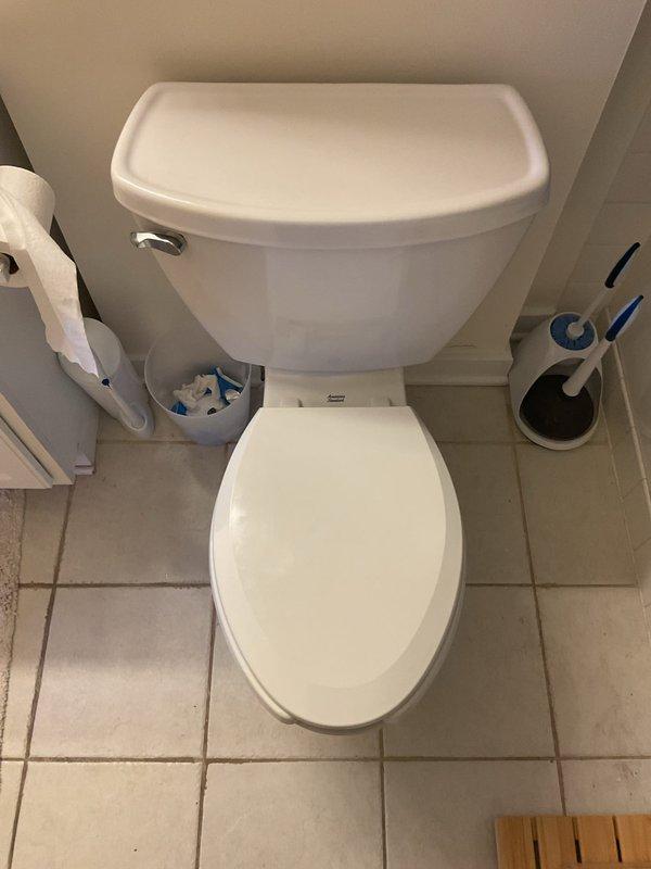 Completed toilet installation in residential bathroom. Installed new two-piece white porcelain toilet with standard flush mechanism and chrome handle. Connected water supply line to tank and verified proper fill valve and flapper operation. Tested flush performance and checked for leaks at all connection points. Ensured proper seating of toilet bowl to floor flange with secure mounting. All components functioning correctly upon completion.