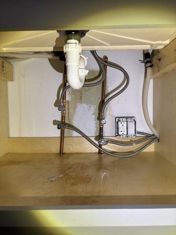 Installed a dedicated shut-off valve for a new dishwasher connection beneath the kitchen sink. The installation involved tapping into the existing copper supply line, adding a quarter-turn angle stop valve with braided stainless steel supply line for easy appliance connection and future maintenance access.