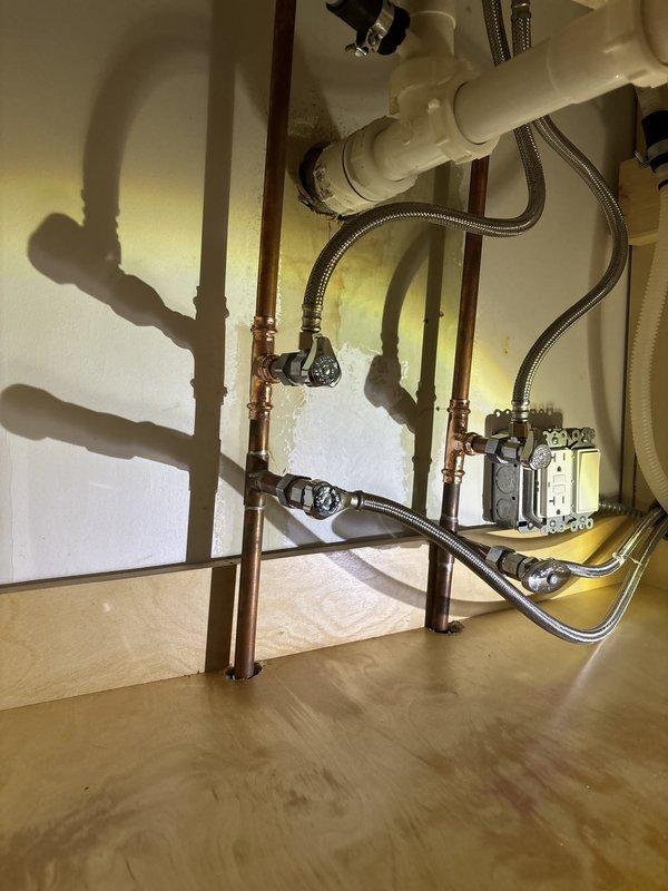 Installed a dedicated shut-off valve for a new dishwasher connection beneath the kitchen sink. The installation involved tapping into the existing copper supply line, adding a quarter-turn angle stop valve with braided stainless steel supply line for easy appliance connection and future maintenance access.