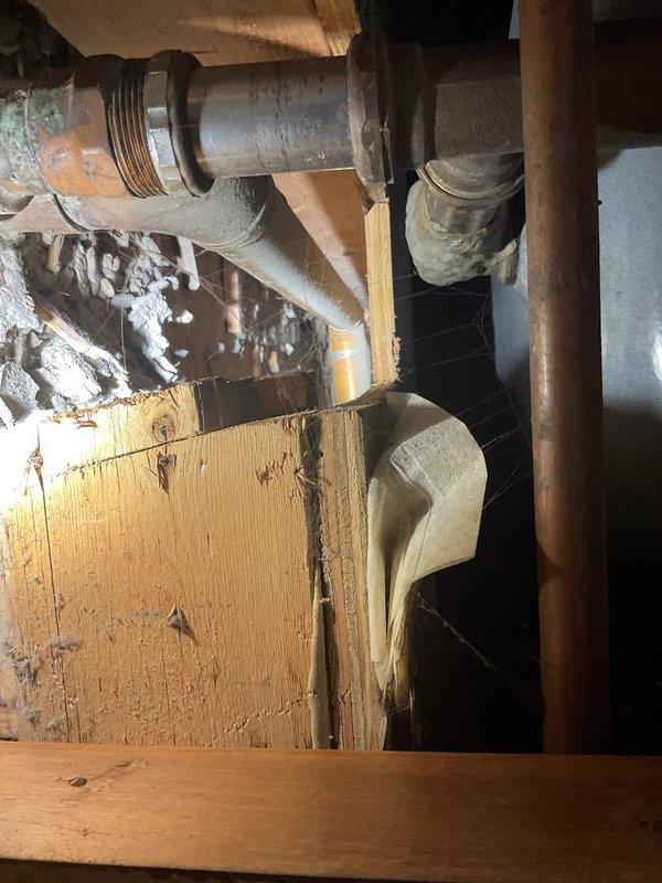 Responded to multiple drain issues across three units in a multi-unit building. Addressed slow-draining kitchen sink in unit 471A, inspected kitchen faucet sprayer leak and drain issue in unit 471B, and evaluated bathtub drain blockage in unit 1B. Accessed crawl space to inspect plumbing infrastructure, including drain lines, water supply pipes, and connections beneath affected fixtures. Documented existing plumbing conditions showing aged galvanized piping with corrosion, mineral deposits on pipe surfaces, and deteriorated insulation around supply lines. Identified drainage concerns related to older pipe infrastructure and potential partial blockages in waste lines serving kitchen and bathroom fixtures.