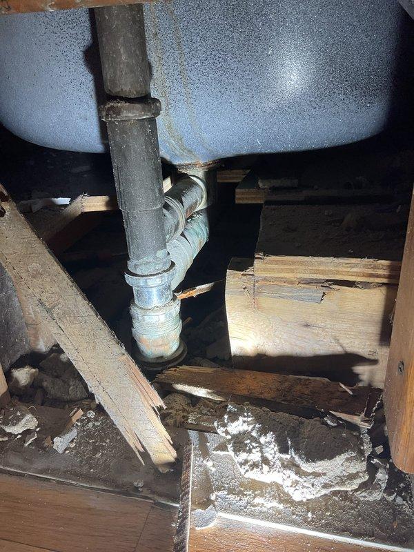 Responded to multiple drain issues across three units in a multi-unit building. Addressed slow-draining kitchen sink in unit 471A, inspected kitchen faucet sprayer leak and drain issue in unit 471B, and evaluated bathtub drain blockage in unit 1B. Accessed crawl space to inspect plumbing infrastructure, including drain lines, water supply pipes, and connections beneath affected fixtures. Documented existing plumbing conditions showing aged galvanized piping with corrosion, mineral deposits on pipe surfaces, and deteriorated insulation around supply lines. Identified drainage concerns related to older pipe infrastructure and potential partial blockages in waste lines serving kitchen and bathroom fixtures.