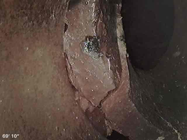 Conducted comprehensive plumbing system inspection of residential property exterior and structural components. Assessed water supply line accessibility near building foundation and evaluated condition of wooden structural support elements showing signs of deterioration and moisture exposure. Documented findings with photographic evidence for repair scheduling and provided recommendation for necessary plumbing repairs to address potential water intrusion issues affecting structural integrity.