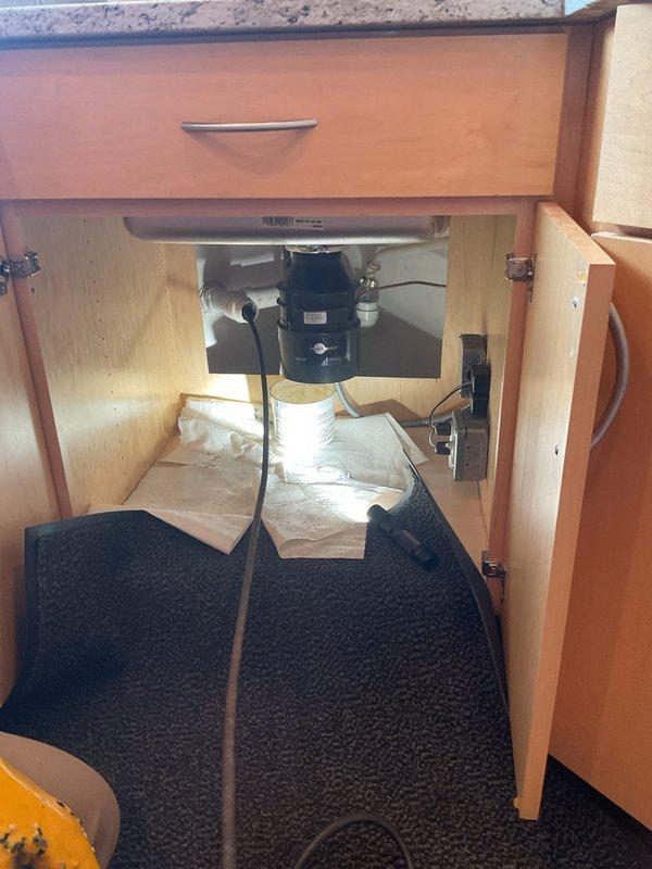 Responded to a clogged bathroom sink that had been draining slowly for several days in a historic 1890s residence. Upon inspection, accessed the under-sink plumbing and removed the drain assembly to extract accumulated hair, debris, and fibrous material causing the blockage. Cleared the obstruction, cleaned the drain components including the strainer, and reassembled the system to restore proper drainage flow.