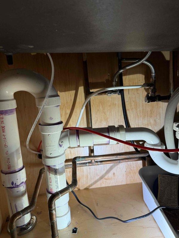 Completed installation of new under-sink plumbing connections including replacement of water supply lines with braided stainless steel flex hoses and reconfiguration of PVC drain assembly. All connections were tested and verified leak-free, with proper valve operation confirmed at fixture mounting points.