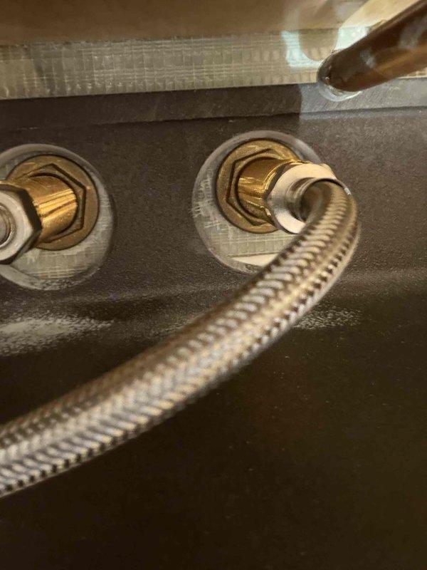 Completed installation of new under-sink plumbing connections including replacement of water supply lines with braided stainless steel flex hoses and reconfiguration of PVC drain assembly. All connections were tested and verified leak-free, with proper valve operation confirmed at fixture mounting points.