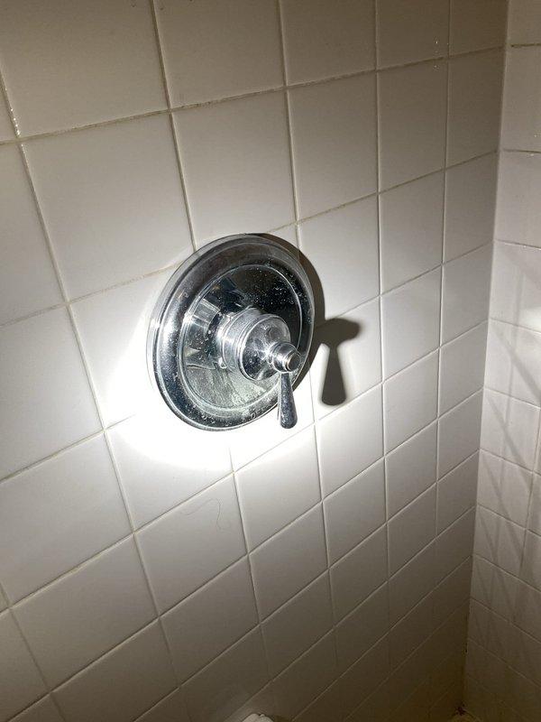 Responded to service call for toilet requiring resealing to floor in en suite bathroom. Upon arrival, inspected the toilet installation and identified compromised wax ring seal between toilet base and closet flange. Removed toilet by disconnecting water supply line and unbolting fixture from floor mounting bolts. Scraped away old wax ring residue from both the closet flange and toilet horn. Inspected flange for damage or deterioration; confirmed flange was secure and in acceptable condition. Installed new wax ring with polyethylene flange to ensure proper seal. Repositioned toilet over flange, ensuring proper alignment with mounting bolts. Secured toilet to floor with new brass closet bolts and caps, torquing evenly to prevent rocking while avoiding over-tightening that could crack the porcelain base. Reconnected water supply line with new compression fitting. Restored water supply and tested for leaks at supply connection and base seal. Cycled toilet multiple times to verify proper fl