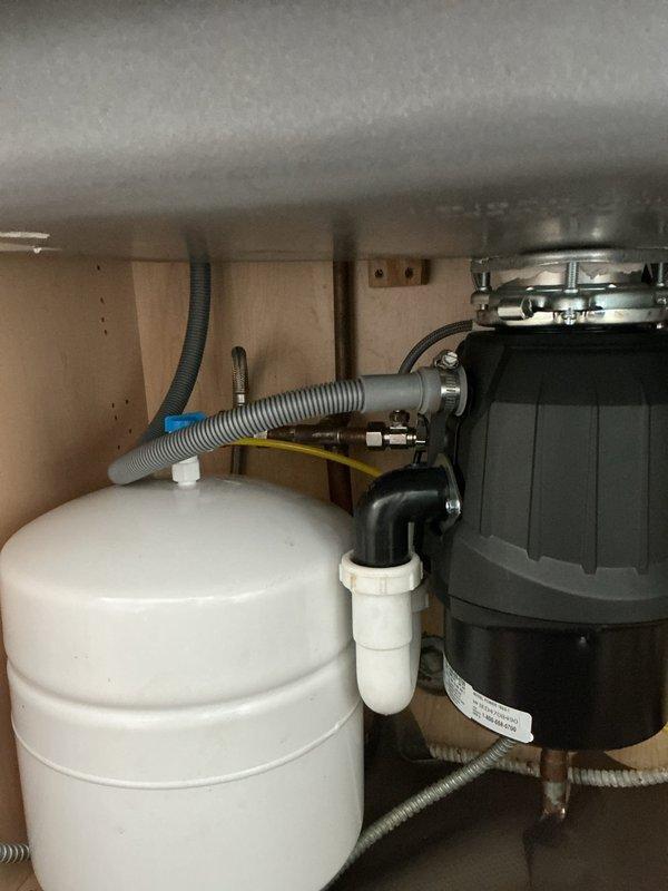 Responded to service call for reverse osmosis system evaluation and potential maintenance needs. Upon arrival, inspected under-sink RO system installation including storage tank, filtration components, and associated plumbing connections. Assessed condition of pre-filters, post-filters, membrane housing, and pressure tank to determine maintenance requirements. Evaluated system performance, checked for leaks at connection points, and verified proper operation of shut-off valves and feed water line. Documented existing system configuration with photos showing current installation layout, component placement, and plumbing connections for maintenance planning purposes.