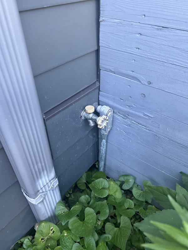 Responded to water leak originating from rear exterior hose bib that was penetrating into the residence along the floor and wall when the faucet was operated. Upon inspection, identified that the supply piping behind the interior cabinet was the source of the leak, which ceased when the faucet was turned off. Accessed the affected plumbing behind the cabinetry to assess the failed connection point. Repaired the compromised piping connection serving the exterior faucet, tested the system under full operating pressure, and verified complete resolution of the interior water intrusion issue.
