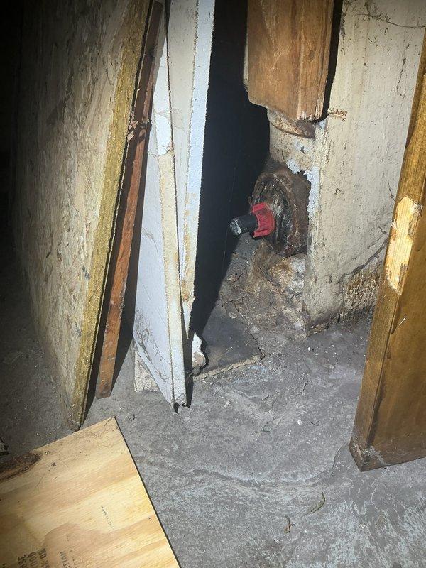 Responded to basement flooding issue caused by rainwater intrusion with standing water present. Assessed existing drainage system including vertical PVC piping configuration along foundation walls. Evaluated structural conditions in basement area, noting water damage patterns and moisture infiltration points at floor-wall junctions. Documented plumbing infrastructure and recommended overflow protection system installation to prevent future flooding events during heavy precipitation.