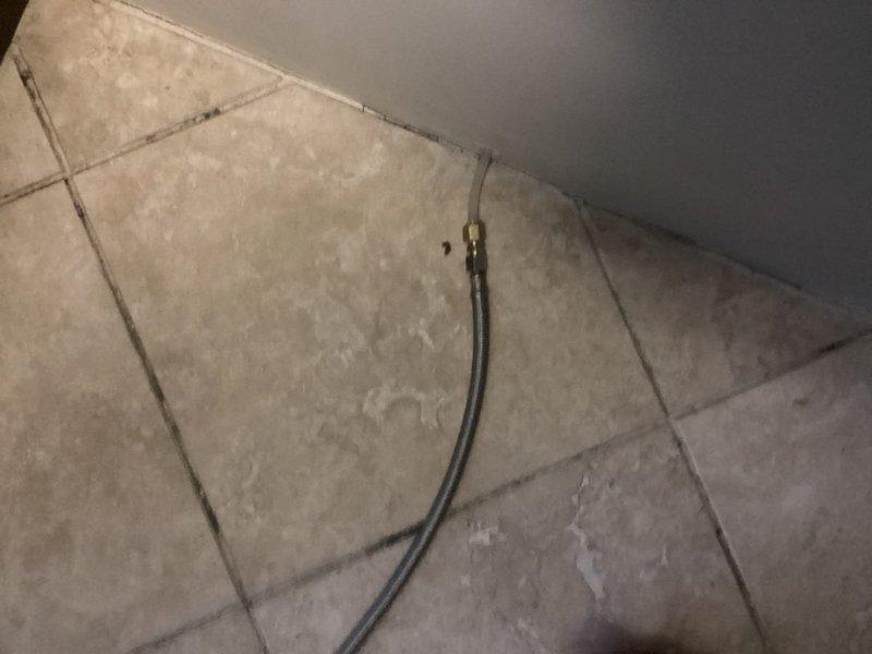 Installed water line hookup for new refrigerator in sixty-year-old residential unit. Connected supply line from existing shut-off valve to refrigerator ice maker and water dispenser using flexible braided stainless steel line with compression fittings. Verified existing ball valve with blue handle was functioning properly and accessible behind appliance. Tested connections for leaks, confirmed adequate water pressure, and ensured proper flow to refrigerator. All connections secured and system operational upon completion.